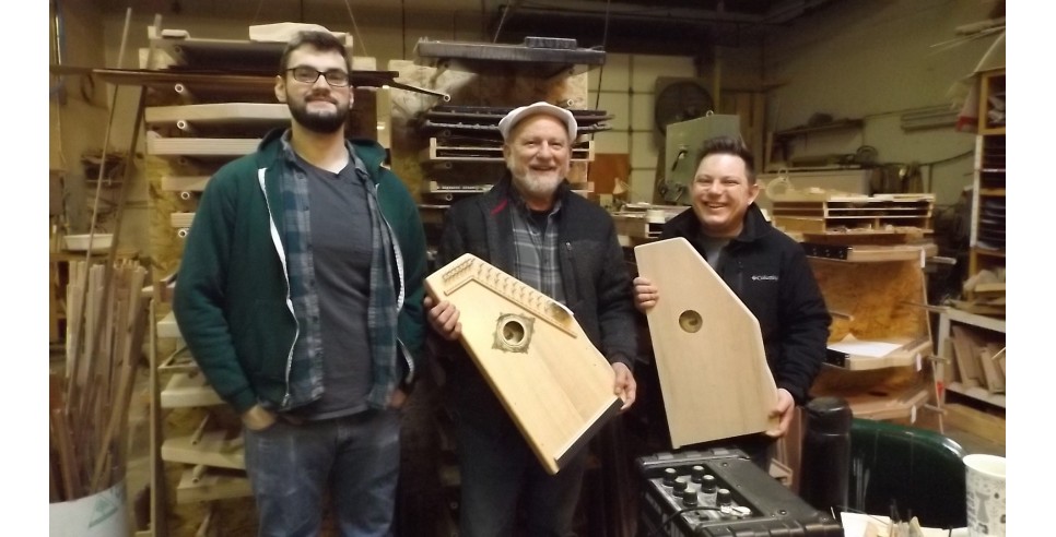 Taking a break from work in the d’Aigle Autoharps workshop to show off some of their instruments: Greg Olson, Pete Daigle and Keith Daigle